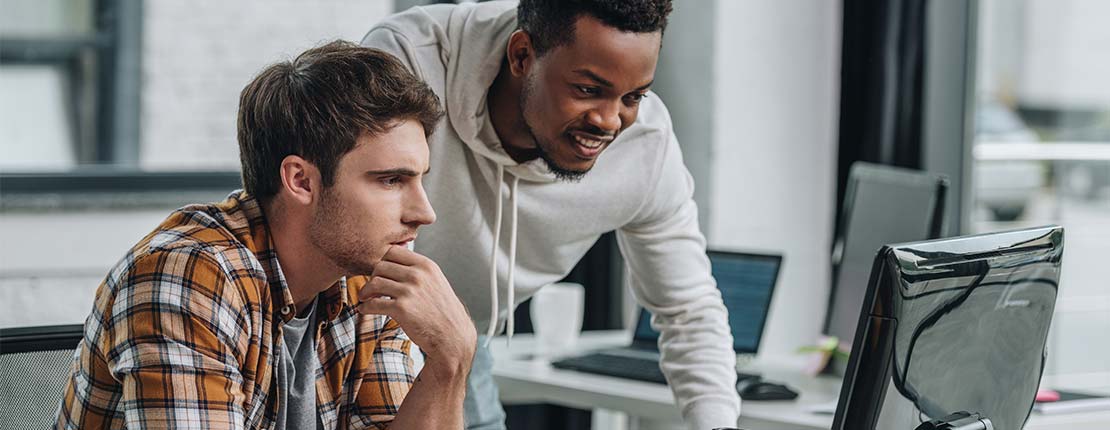 Software engineers looking at screen